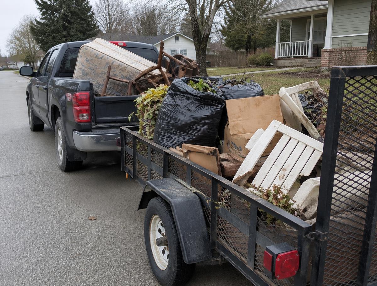 My truck and trailer loaded with a mattress, chairs and yard waste